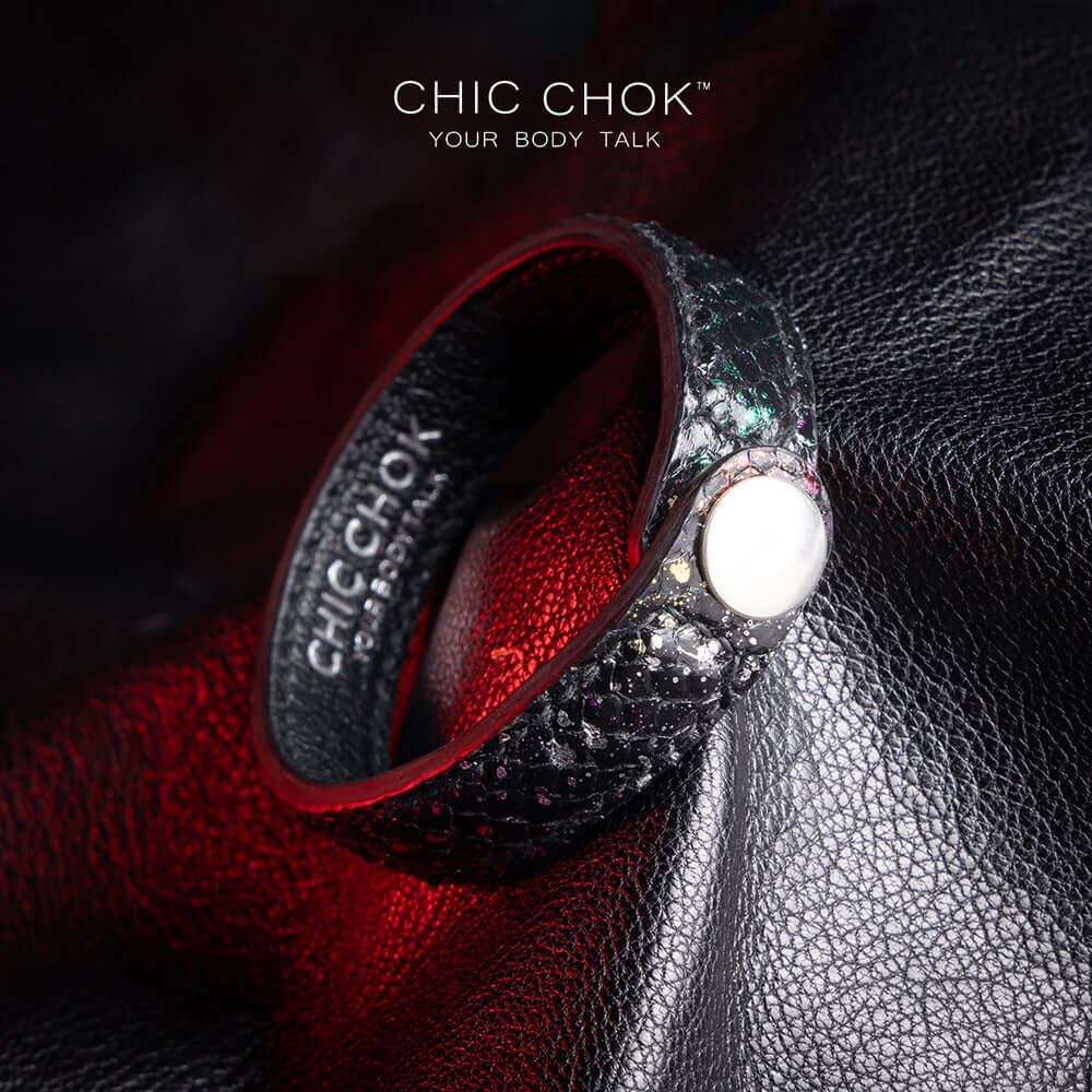 Nebula Doll Bracelet Luxurious black leather bracelet with textured scales, adorned with shimmering multicolor glitter accents, inspired by the brilliance of a starry night sky, showcasing elegance and individuality.