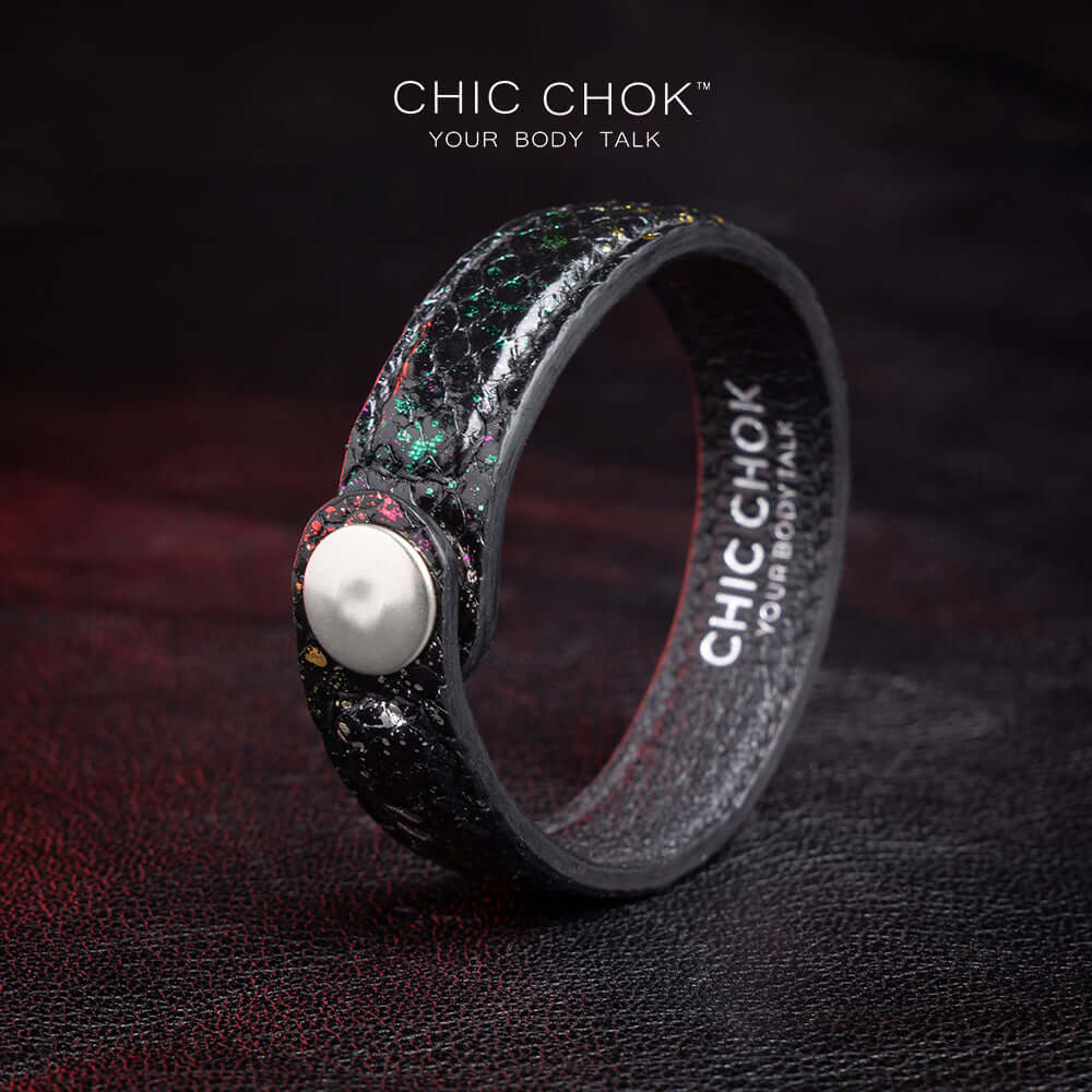 Nebula Doll Bracelet Luxurious black leather bracelet with textured scales, adorned with shimmering multicolor glitter accents, inspired by the brilliance of a starry night sky, showcasing elegance and individuality.