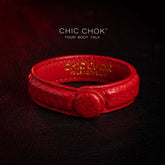 chicchok red scaled leather bracelet featuring a bold circular clasp and luxurious gold branding, designed to inspire confidence and elevate any outfit